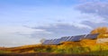 Photoelectric batteries on the background of a blue sky with clouds