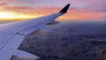 Photograph of an airplane showing the commercial wide-body wing ascending to the height of the cruising clouds. Royalty Free Stock Photo