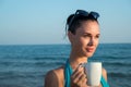 Photograph of a beautiful brunette woman with white mug with tea Royalty Free Stock Photo