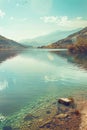 photograph of the beautiful lake with clear water, surrounded hills and mountains Royalty Free Stock Photo