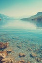 photograph of the beautiful lake with clear water, surrounded hills and mountains Royalty Free Stock Photo