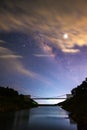 Photograph of beautiful milky way rising over the bridge at the damp in Chiang Mai city, Thailand Royalty Free Stock Photo