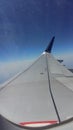 Photograph blue sky cloud taken from inside the plane.