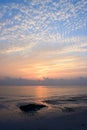 Pattern of Clouds in Morning Bright Sky with Rising Sun at Horizon over Ocean Royalty Free Stock Photo