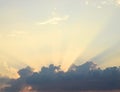 Golden Yellow Crepuscular Sun Beams from Dark Clouds in Bright Sky - Natural Background Skyscape