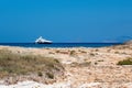 calm torquoise Balearic sea in the sunny day with luxurious boat arriving to the Formentera beach