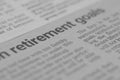 The photograph captures a close-up view of a newspaper section, with a focus on the text \'RETIREMENT GOALS
