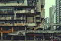 This photograph captures the impressive stature of a towering building adorned with numerous windows and balconies, Brutalist