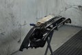 The photograph captures the scene of an automotive workshop, showcasing the process of painting various car parts.