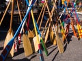 Colorful wooden boat paddles standing in a market