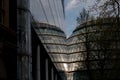 Photograph of City Hall, London taken from the rear at dusk. Building is reflected in the glass facade of the adjacent building. Royalty Free Stock Photo