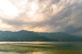 Photograph of cloud, lake, mountain and reflexion Near Pokhara Lake at Kathmandu Nepal. Snap in portrait, landscape, wide screen.