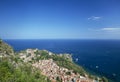 Photograph of the coast of Taormina in Sicily, houses, boats and trees