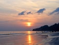 Bright Golden Yellow Sun Setting over Ocean with Colorful Sky at Crowded Radhanagar Beach, Havelock Island, Andaman, India