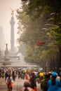 Photograph of cyclists at Mexico City. Angel Independencia behind