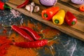 Assortment of peppers, garlic and onions on a stone countertop Royalty Free Stock Photo