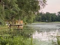 Photograph of a dock at sunset on a lake