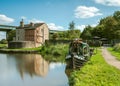 A photograph documenting a converted canal narrowboat acts as a tearoom with a small outdoor garden seating area Royalty Free Stock Photo