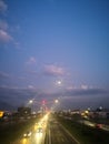 Photograph of a double-lane road at the end of the day when the sky is nuanced