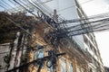 Photograph of an electric pole with lots of cables on it on the street of Bangkok, Royalty Free Stock Photo