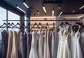 Photograph of elegant wedding dresses hanging on hangers in a luxury store, wedding dress in the showroom of a bridal boutique