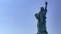 Photograph of the famous statue of liberty of the Big Apple and Manhattan seen from the back. Royalty Free Stock Photo