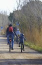 photograph of father and children riding a bike in daylight