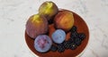 Photograph of figs, blackberries, and plums