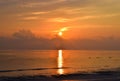 Golden Sun Rising at Horizon with Warm Colors in Sky with Reflection in Sea Water - Kalapathar Beach, Havelock Island, Andaman Royalty Free Stock Photo