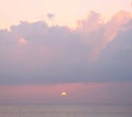 Golden yellow sun setting over ocean with dark clouds in bright pinkish sky - Laxmanpur, Neil Island, Andaman, India