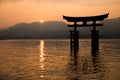 Photograph of the great torii of Miyajima surrounded by water at sunset