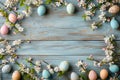 Photograph of green and blue Easter eggs and flowers on a wooden table Royalty Free Stock Photo