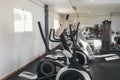 Photograph of a gym with exercise machines. Ellipticals, treadmills. sport concept