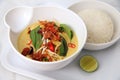 Healthy delicious curry asian food in bowl with rice on the side and lime