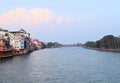 The Holy River Ganges - Ganga with both Banks, Buildings and White Clouds in Blue Sky - Haridwar, Uttarakhand, India Royalty Free Stock Photo