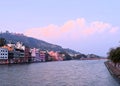 The Holy River Ganges - Ganga with Buildings, Temples, and Ghats on Banks and Cloudy Blue Sky - Haridwar, Uttarakhand, India Royalty Free Stock Photo