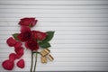 Romantic winter food photography image with luxury chocolate biscuits and red rose flowers on white wood copy space background