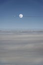 Air plane flies through a full moon way above the clouds. Royalty Free Stock Photo