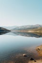 Photograph of the lake in front of hills, clear sky, reflection on the water Royalty Free Stock Photo