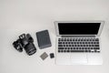 a laptop with digital camera and storage on table in white background Royalty Free Stock Photo