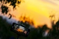 Photograph on a mobile phone while recording a sunset time lapse with a sun over the sky of Madrid, Spain. Europe. Royalty Free Stock Photo