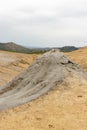 Photograph of muddy volcanoes in Buzau, Romania, showing gray lava and cracked volcanic soil Royalty Free Stock Photo