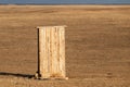 Photograph of an old rural outhouse or toilet in steppe. Single wooden building Royalty Free Stock Photo