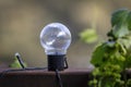 Photograph of an ornamental light globe on a wooden deck of a residential house