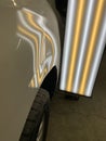 A large dent on a quarter panel of a vehical