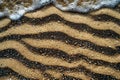 Photograph of sand texture background, top view of beach sand with small waves Royalty Free Stock Photo