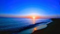 This photograph shows a sunset on the serene water beach at the optimum color point