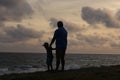 Photograph of a son and father enjoying the sun set good for fathers day celebration