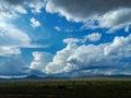 Photograph summer bright blue sky white clouds rain mountains hills green