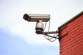 Surveillance camera and red brick wall